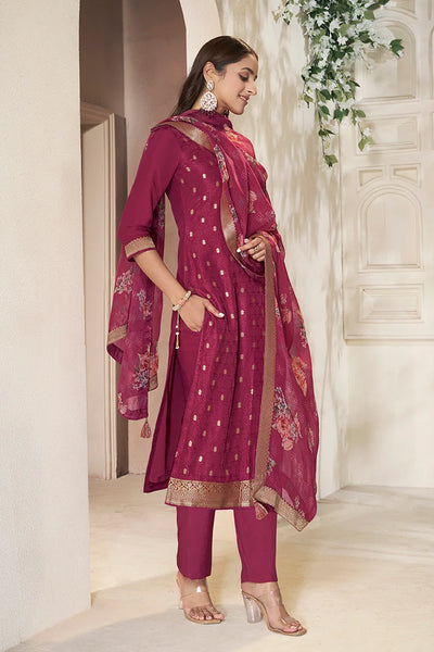 Woman in a maroon kurta set traditional outfit with a matching dupatta in a decorative settingWoman in a maroon kurta set traditional outfit with a matching dupatta in a decorative setting