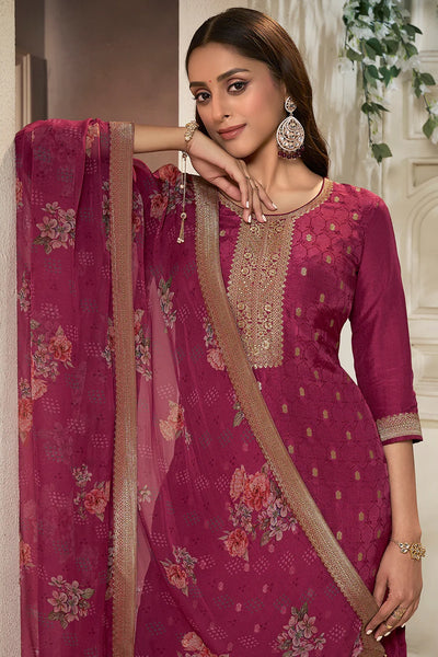 Woman wearing a maroon traditional outfit with floral patterns and embroidery.Woman wearing a maroon traditional outfit with floral patterns and embroidery.