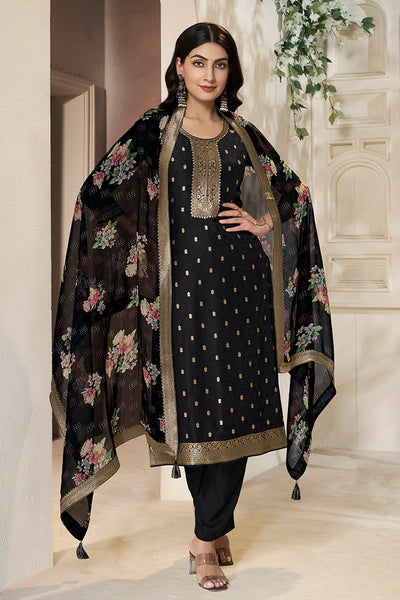 Woman wearing a black kurta set traditional outfit with floral embroidery dupatta in an indoor settingWoman wearing a black kurta set traditional outfit with floral embroidery dupatta in an indoor setting