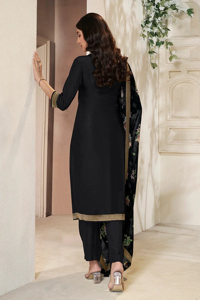 Woman in a black traditional kurta set outfit walking through a doorway.Woman in a black traditional kurta set outfit walking through a doorway.