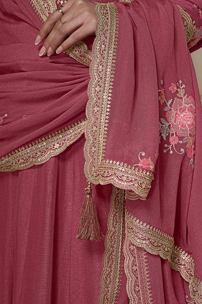 Close-up of a pink anarkali dress with gold and pink embroideryClose-up of a pink anarkali dress with gold and pink embroidery