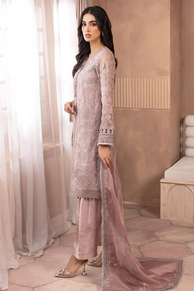 Woman in a pink embroidered salwar suit traditional outfit standing in a room with beige walls and white curtains.Woman in a pink embroidered salwar suit traditional outfit standing in a room with beige walls and white curtains.