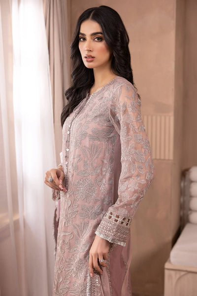 Woman wearing a light pink embroidered salwar suit traditional outfit indoors.Woman wearing a light pink embroidered salwar suit traditional outfit indoors.