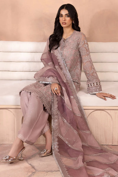 Woman in a traditional salwar suit outfit with intricate embroidery sitting on a white bench.Woman in a traditional salwar suit outfit with intricate embroidery sitting on a white bench.