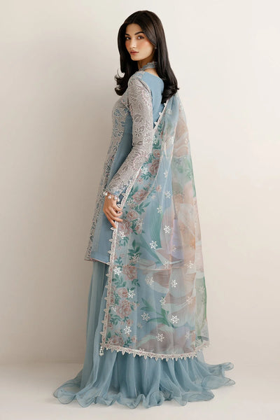 Woman wearing a traditional outfit with embroidered chiffon anarkali top and light blue palazzo pants on a plain backgroundWoman wearing a traditional outfit with embroidered chiffon anarkali top and light blue palazzo pants on a plain background