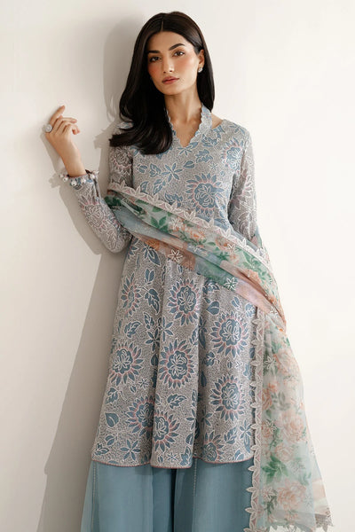 Woman wearing a traditional outfit with embroidered chiffon anarkali top and light blue palazzo pants on a plain backgroundWoman wearing a traditional outfit with embroidered chiffon anarkali top and light blue palazzo pants on a plain background
