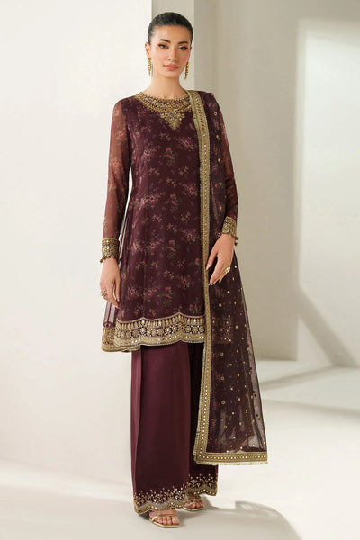 Woman wearing a traditional salwar suit outfit with a long embroidered kameez and matching salwar on a plain background