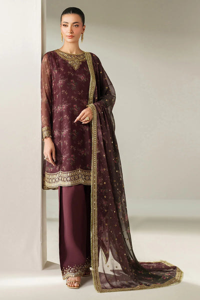 Woman wearing a traditional salwar suit outfit with a long embroidered kameez and matching salwar on a plain backgroundWoman wearing a traditional salwar suit outfit with a long embroidered kameez and matching salwar on a plain background