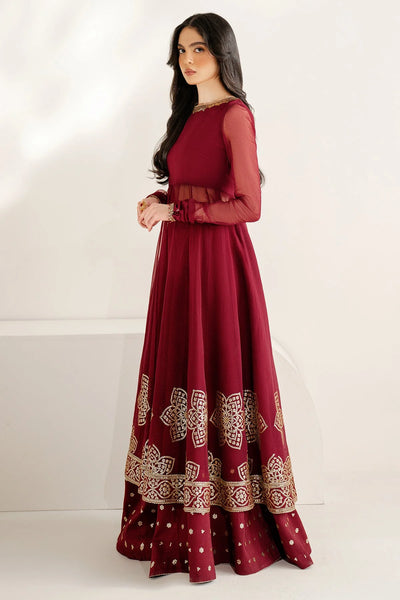 Woman wearing a long maroon anarkali dress with gold embroidery on a white backgroundWoman wearing a long maroon anarkali dress with gold embroidery on a white background