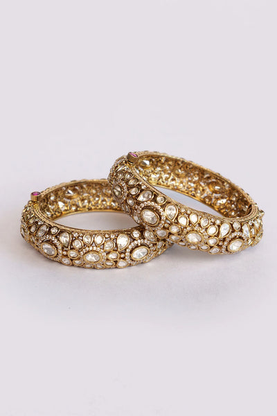 Pair of bridal bangles with gemstones on a light gray backgroundPair of bridal bangles with gemstones on a light gray background