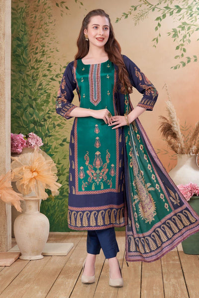 Woman wearing a green and blue embroidered traditional kurta pant style outfit with a floral background