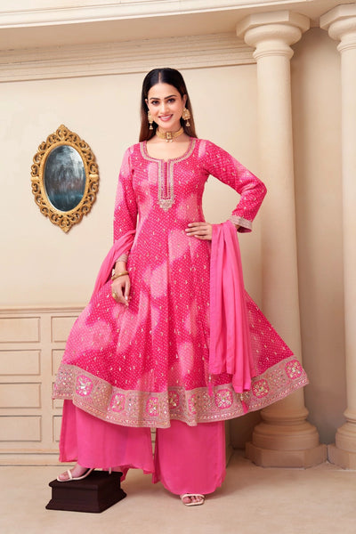 Woman wearing a pink traditional outfit with a decorative background