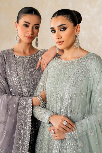 Woman wearing a light green traditional wedding sharara outfit with a matching dupatta in a room.Woman wearing a light green traditional wedding sharara outfit with a matching dupatta in a room.