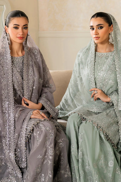 Woman wearing a light green traditional wedding sharara outfit with a matching dupatta in a room.Woman wearing a light green traditional wedding sharara outfit with a matching dupatta in a room.