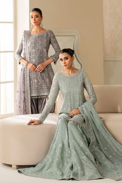 Woman wearing a light green traditional wedding sharara outfit with a matching dupatta in a room.Woman wearing a light green traditional wedding sharara outfit with a matching dupatta in a room.
