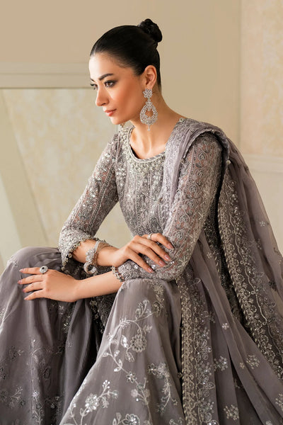 Woman in a gray embroidered traditional outfit with a plain backgroundWoman in a gray embroidered traditional outfit with a plain background
