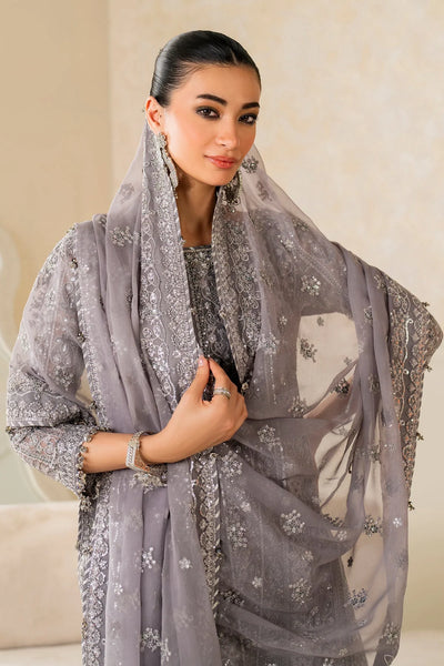 Woman wearing a gray embroidered dupatta with a neutral backgroundWoman wearing a gray embroidered dupatta with a neutral background