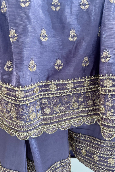 Close-up of a blue fabric with gold embroideryClose-up of a blue fabric with gold embroidery