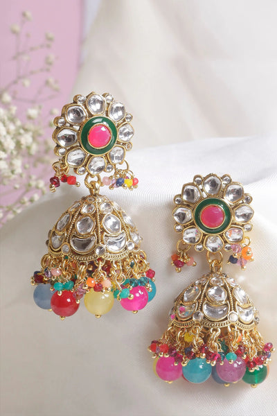 Colorful earrings with intricate designs on a light background
