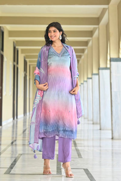 Woman in a colorful outfit walking down a hallway