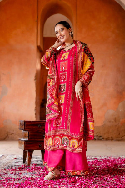 Woman in a vibrant traditional outfit standing in front of an orange wall with arches.Woman in a vibrant traditional outfit standing in front of an orange wall with arches.