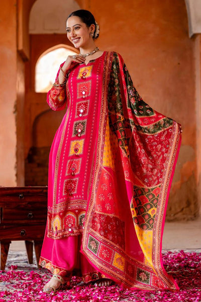 Woman in a traditional Hot Pink Crepe Silk Palazzo Style Kurta Set outfit standing in a warm-toned interior setting.
