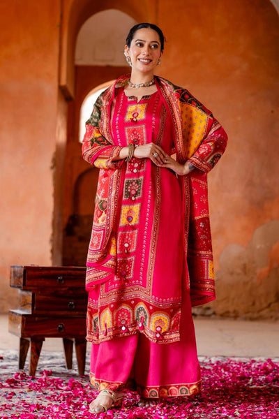 Woman in traditional red and pink embroidered outfit standing in a warm-toned architectural setting.Woman in traditional red and pink embroidered outfit standing in a warm-toned architectural setting.