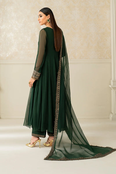 Woman wearing a green traditional outfit with a long scarf in a neutral settingWoman wearing a green traditional outfit with a long scarf in a neutral setting
