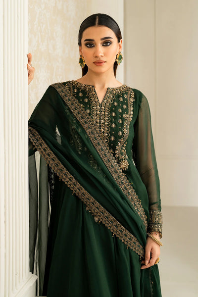 Woman wearing a dark green traditional anarkali outfit with intricate embroidery in a neutral settingWoman wearing a dark green traditional anarkali outfit with intricate embroidery in a neutral setting