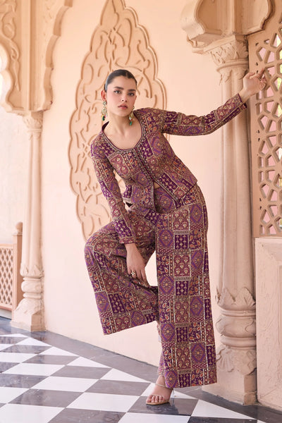 Woman in a embroidered palazzo outfit standing in an ornate architectural settingWoman in a embroidered palazzo outfit standing in an ornate architectural setting