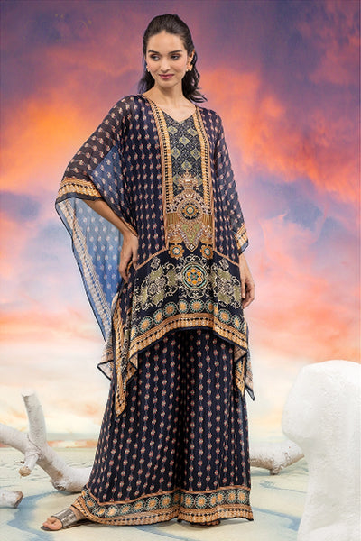 Woman wearing a traditional outfit with intricate patterns against a colorful sky background