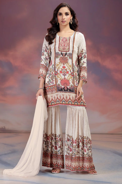Woman wearing a traditional outfit with intricate patterns against a scenic background