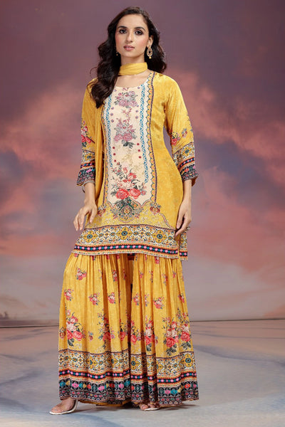 Woman wearing a yellow traditional outfit with floral patterns against a pink and purple gradient background