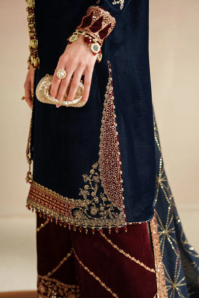 Navy blue and red traditional outfit with intricate gold embroidery on a neutral backgroundNavy blue and red traditional outfit with intricate gold embroidery on a neutral background