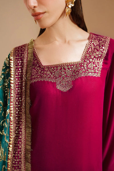 Woman wearing a traditional pink velvet kurta salwar outfit with green dupatta against a beige backgroundWoman wearing a traditional pink velvet kurta salwar outfit with green dupatta against a beige background