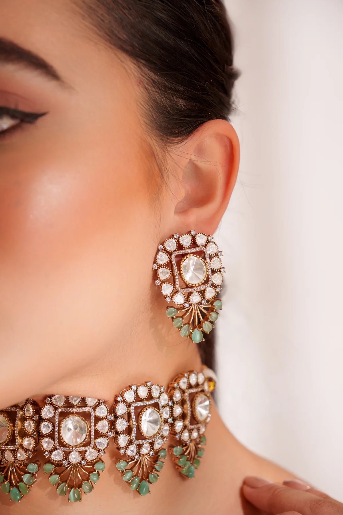 Close-up of a woman wearing Gold Finish Mint Green Polki Choker Necklace Set