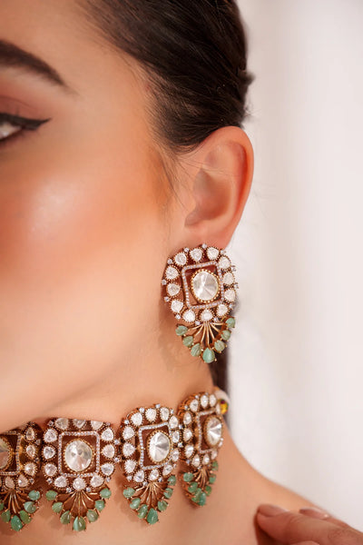 Close-up of a woman wearing Gold Finish Mint Green Polki Choker Necklace SetClose-up of a woman wearing Gold Finish Mint Green Polki Choker Necklace Set