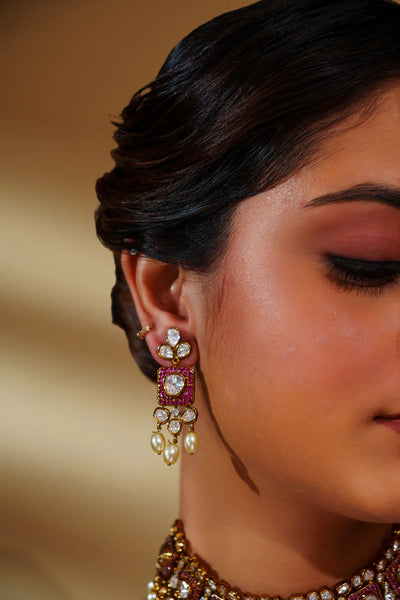 Close-up of a woman wearing ornate earrings with a blurred backgroundClose-up of a woman wearing ornate earrings with a blurred background