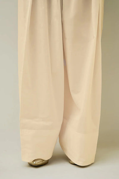 Beige farshi shalwar pants on a plain backgroundBeige farshi shalwar pants on a plain background