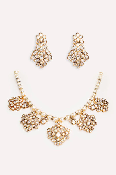 Gold Kundan Polki Necklace Set with Pearl Strand Dual Tone Finish set on a white backgroundGold Kundan Polki Necklace Set with Pearl Strand Dual Tone Finish set on a white background