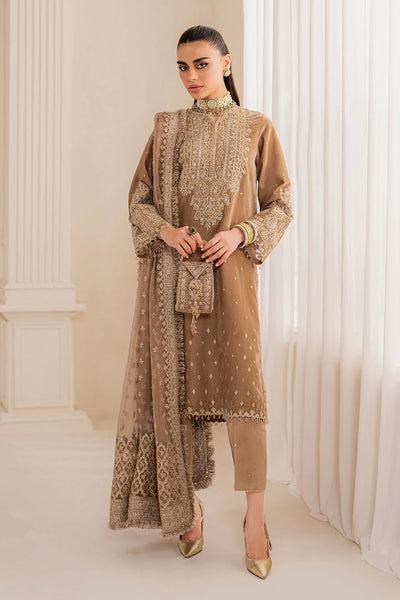 Woman wearing a beige velvet salwar suit embroidered outfit in a minimalistic setting