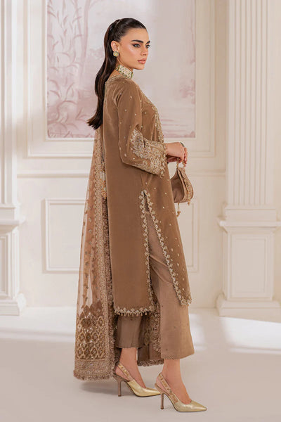 Woman wearing a beige velvet salwar suit embroidered outfit in a minimalistic settingWoman wearing a beige velvet salwar suit embroidered outfit in a minimalistic setting