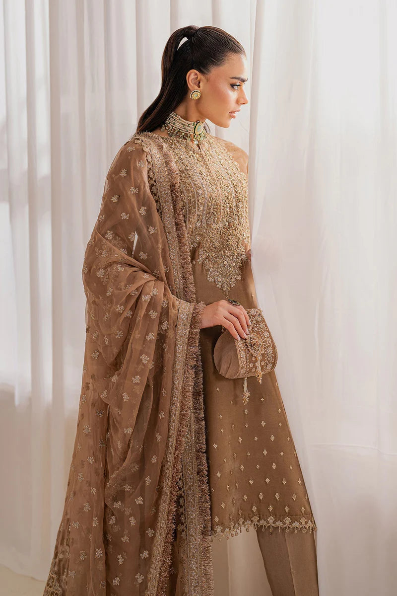 Woman wearing a beige velvet salwar suit embroidered outfit in a minimalistic setting