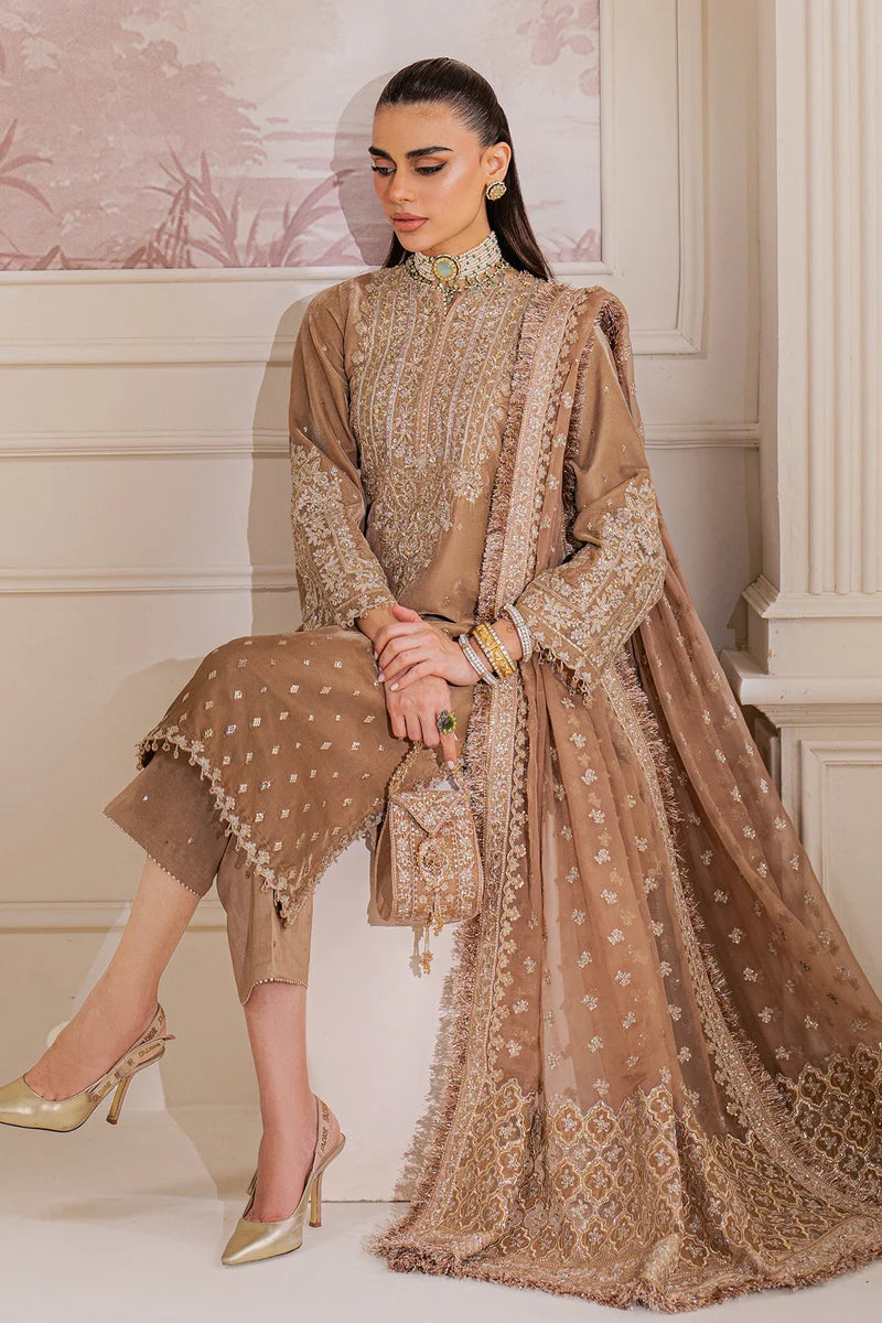 Woman wearing a beige velvet salwar suit embroidered outfit in a minimalistic setting