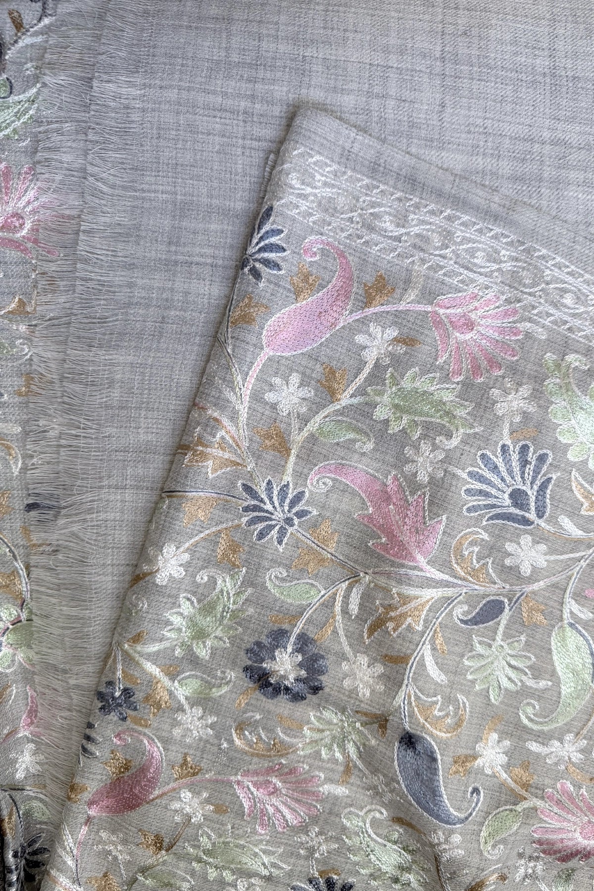 Embroidered shawl with floral kashmiri work on a gray background