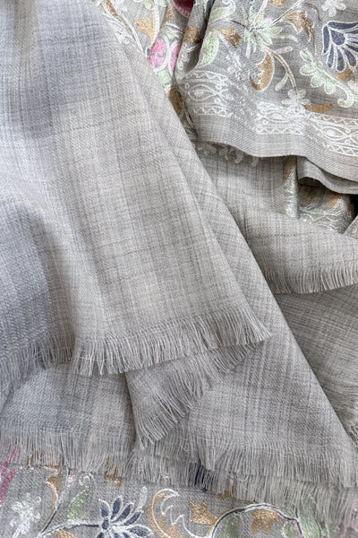 Embroidered shawl with floral kashmiri work on a gray backgroundEmbroidered shawl with floral kashmiri work on a gray background