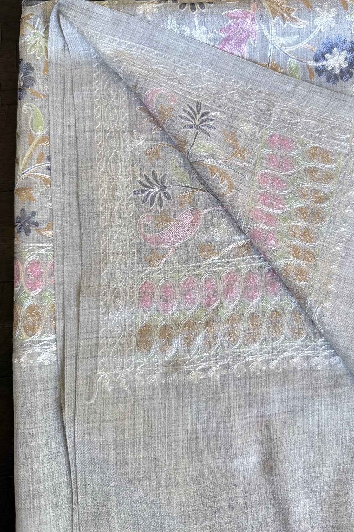 Embroidered shawl with floral kashmiri work on a gray background
