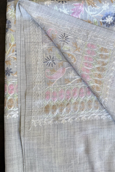Embroidered shawl with floral kashmiri work on a gray backgroundEmbroidered shawl with floral kashmiri work on a gray background