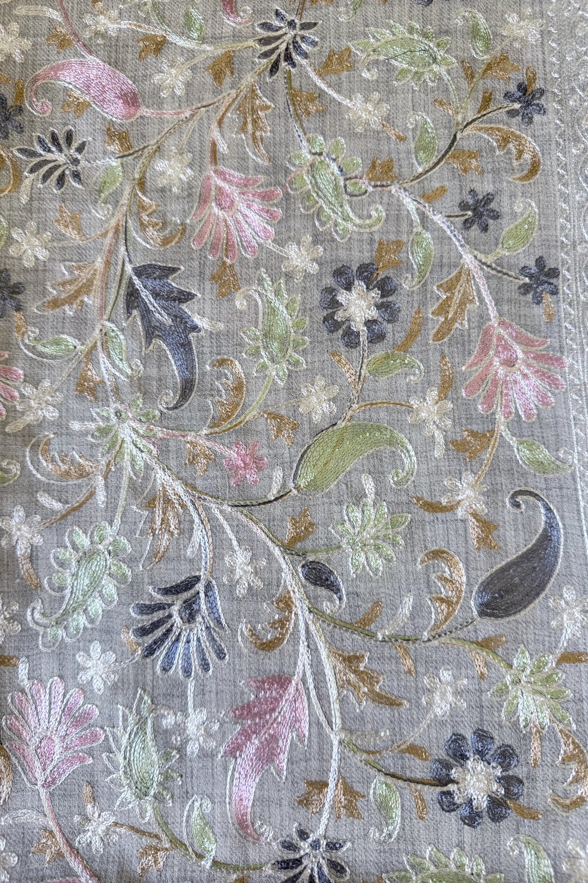 Embroidered shawl with floral kashmiri work on a gray background