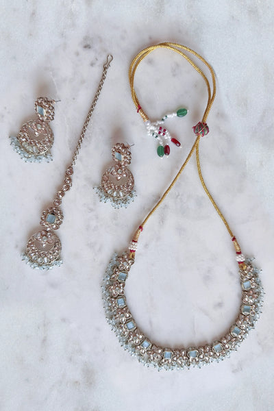 Necklace and earrings, tikka set on a marble surface